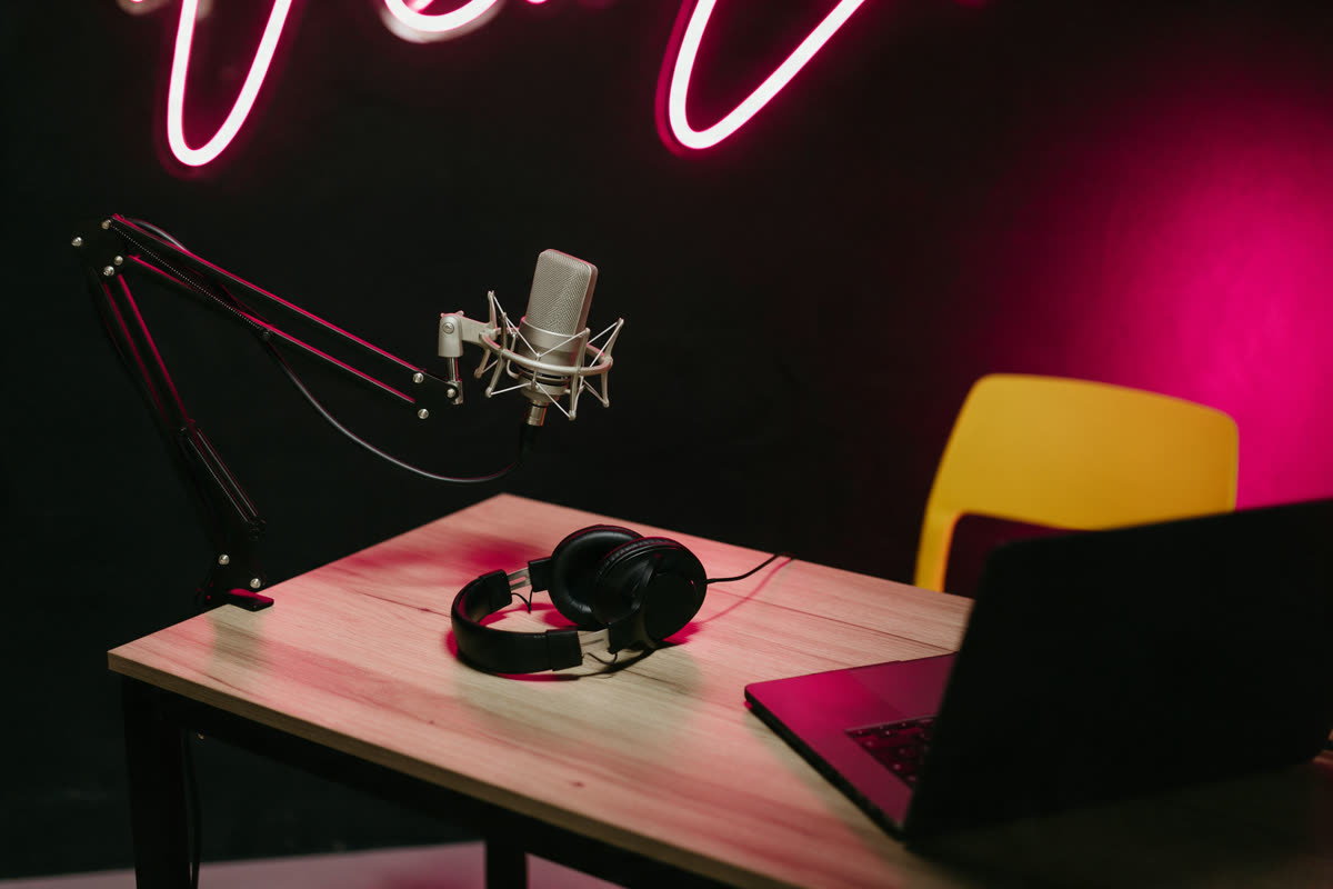 Podcast studio with pink neon Podcast studio with a microphone on a boom arm under pink neon light